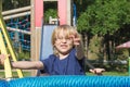 Young blond boy is playing at monkey bars. Royalty Free Stock Photo