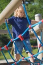 Young blond boy is playing at monkey bars. Royalty Free Stock Photo