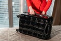 Close-up unpacks suitcase Young blond businesswoman arrives in a hotel room with black suitcase. Woman in red coral Royalty Free Stock Photo