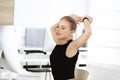 Young blond businesswoman working on computer while sitting at the desk in modern office. Business people concept. Black Royalty Free Stock Photo