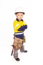 Young blond caucasian boy arms folded or on his hips role playing as an angry construction worker Royalty Free Stock Photo