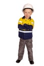 Young blond caucasian boy arms folded role playing as an angry construction worker in a yellow and blue hi-viz shirt, boots Royalty Free Stock Photo