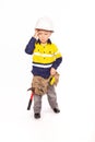 Young blond caucasian boy scratching his head in disbelief role playing as a frustrated construction worker Royalty Free Stock Photo