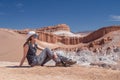 Young blond caucasian girl sitting and admiring outstanding landscape of untouched nature in Atacama desert, Chile Royalty Free Stock Photo