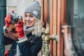 Young blond curly female shooting photo on old film camera Royalty Free Stock Photo