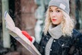 Young blond curly girl with map of London, winter Royalty Free Stock Photo