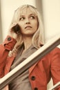 Young blond fashion business woman in red jacket calling on cell phone Royalty Free Stock Photo