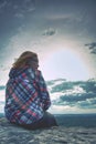 A young blond girl sit on peak and enjoy sun. Woman hiker Royalty Free Stock Photo