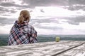 Young blond girl trekker resting at wooden table