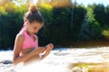 Young blond girl using smartphone outdoors Royalty Free Stock Photo