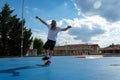 Young blond guy performing skateboarding tricks jumping in the skatepark Royalty Free Stock Photo