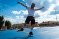 Young blond guy performing skateboarding tricks jumping in the skatepark Royalty Free Stock Photo