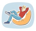 Young blond guy resting on a bean bag chair Royalty Free Stock Photo