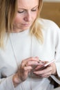 Young blond hair business woman writing a text message using mes Royalty Free Stock Photo