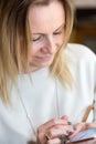 Young blond hair business woman writing a text message using mes Royalty Free Stock Photo