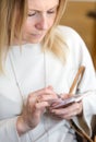 Young blond hair business woman writing a text message using mes Royalty Free Stock Photo