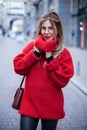 Young blond happy smiling in red knitted sweater. Outdoor portrait close-up. Winter warm clothes. It`s Christmas time Royalty Free Stock Photo