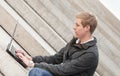 Young blond man with laptop