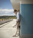 Young blond man on a roof