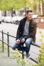 Young blond man sitting outside Royalty Free Stock Photo