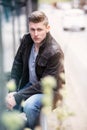 Young blond man sitting outside Royalty Free Stock Photo