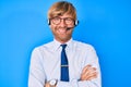 Young blond man wearing call center agent headset happy face smiling with crossed arms looking at the camera Royalty Free Stock Photo