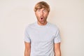 Young blond man wearing casual clothes afraid and shocked with surprise expression, fear and excited face Royalty Free Stock Photo