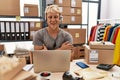 Young blond man wearing operator headset working at online shop happy face smiling with crossed arms looking at the camera Royalty Free Stock Photo