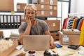 Young blond man wearing operator headset working at online shop thinking looking tired and bored with depression problems with Royalty Free Stock Photo