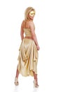 Young blond model with a golden dress Royalty Free Stock Photo