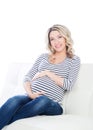 Young blond pregnant woman in a striped shirt