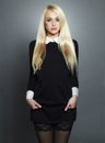 Young blond woman.Beautiful Girl in black dress.schoolgirl Royalty Free Stock Photo
