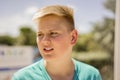 Young blond teenage boy looking to the side