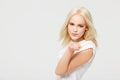 Young blond woman blowing a kiss with love and smile against a white studio background. Portrait of beautiful isolated Royalty Free Stock Photo