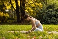 Young woman doing yoga exercise outdoor in the park, sport yoga concept Royalty Free Stock Photo