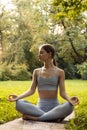 Young woman doing yoga exercise outdoor in the park, sport yoga concept Royalty Free Stock Photo