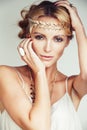 Young blond woman dressed like ancient greek godess, gold jewelry close up isolated, beautiful girl hands manicured red