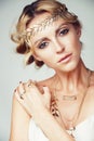 Young blond woman dressed like ancient greek godess, gold jewelry close up isolated, beautiful girl hands manicured red