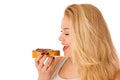 Young blond woman eating breakfast bread and nougat spread isolated over white background Royalty Free Stock Photo