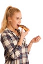 Young blond woman eating breakfast bread and nougat spread isolated over white background Royalty Free Stock Photo