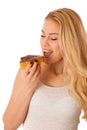 Young blond woman eating breakfast bread and nougat spread isolated over white background Royalty Free Stock Photo