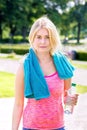 Young blond woman finished with jogging. Royalty Free Stock Photo