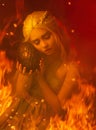 A young blond woman in a gray dress is sitting on fire and hugging a dragon egg Royalty Free Stock Photo
