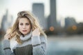 A young blond woman holding blowing hair in front of Lake Michigan and Chicago skyline. Royalty Free Stock Photo