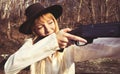 Young blond woman holding up a gun Royalty Free Stock Photo