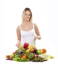 A young blond woman and a pile of fresh fruits Royalty Free Stock Photo