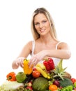 A young blond woman and a pile of fresh fruits