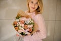 Beautiful smiling young woman with a bouquet of flowers in pastel colors Royalty Free Stock Photo