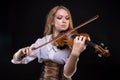 Young blond woman playing the fiddle Royalty Free Stock Photo