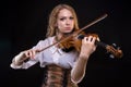 Young blond woman playing the violin Royalty Free Stock Photo